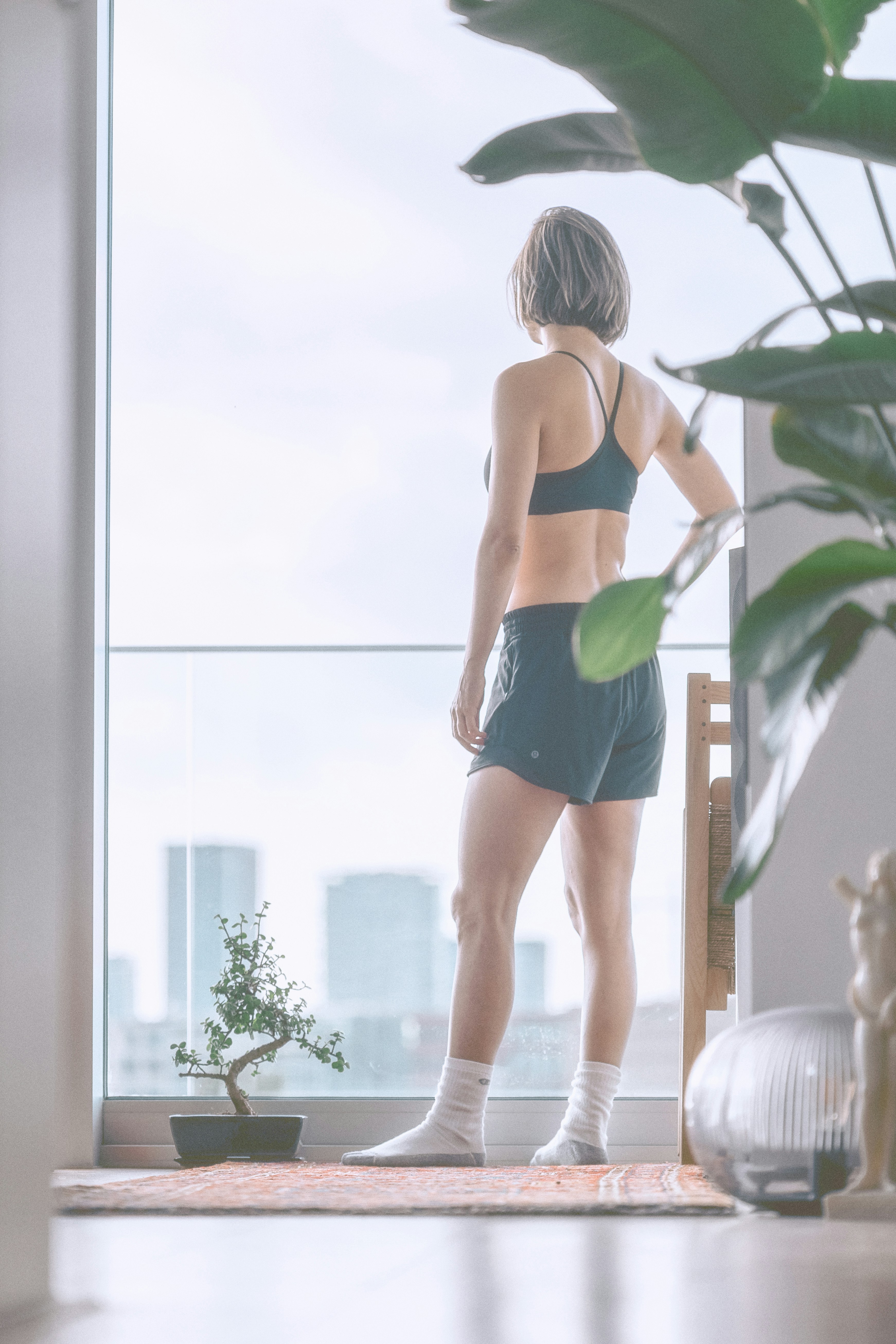 Woman at home in warm morning light, content and at ease